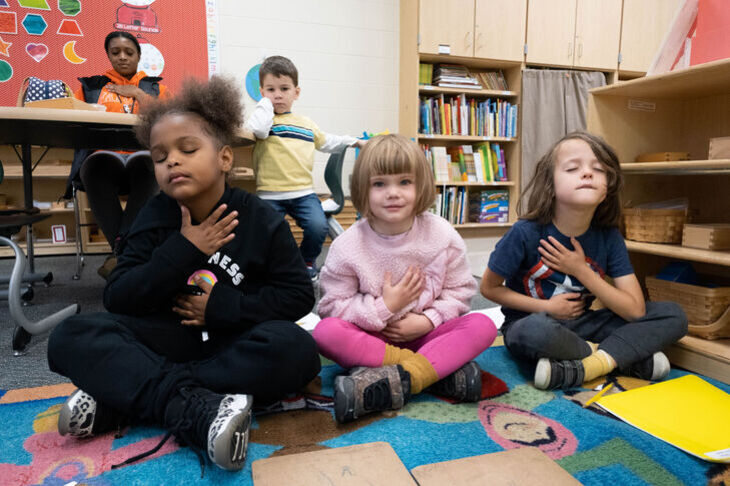 Kindergarten students and their teacher listening to Mindful Music