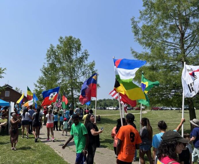 People walking with flags of nations around the world