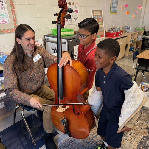 Students at St Cecilia feel a cello during a special Mindful Music workshop.